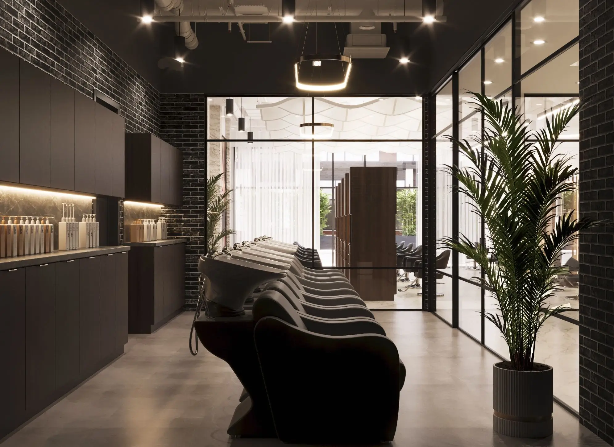 Shampoo 4-1 A modern hair salon interior with black chairs lined up at wash stations, dark walls, large windows, and a potted plant in the corner. - Jax Salon and Spa